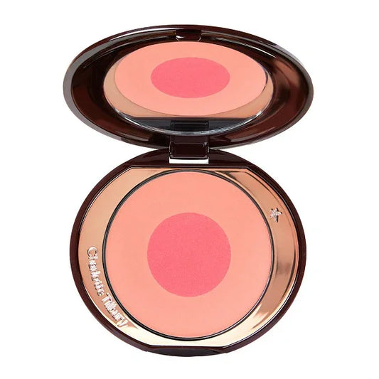 Open compact with pink and peach powder blush in circular pan, makeup product.