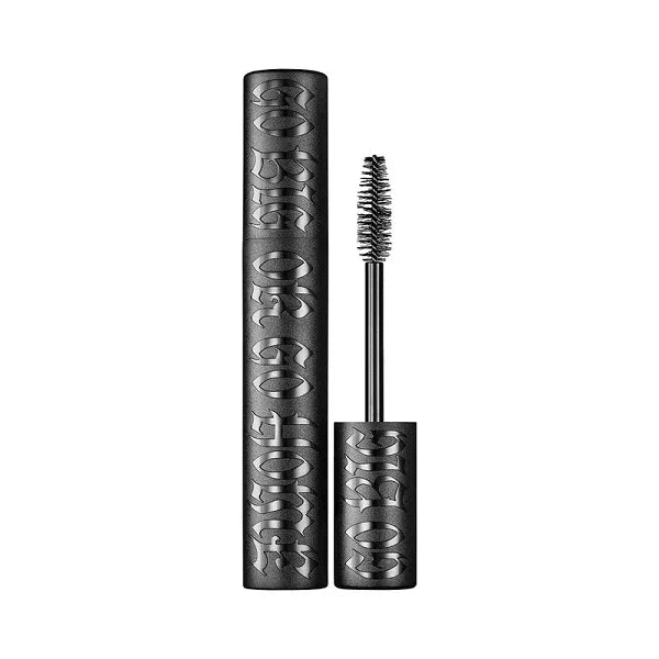 Black volumizing mascara tube with textured lettering and mascara wand on white background
