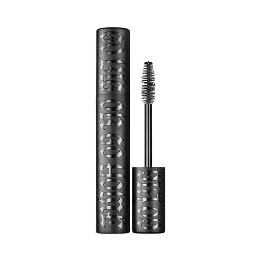 Black volumizing mascara tube with textured lettering and mascara wand on white background