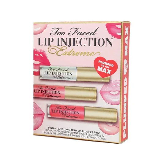 Three lip gloss tubes in gold packaging displayed on a pink box labeled 'Lip Injection Extreme'.
