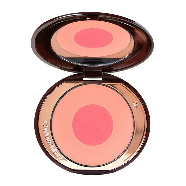 Open compact with pink and peach powder blush in circular pan, makeup product.