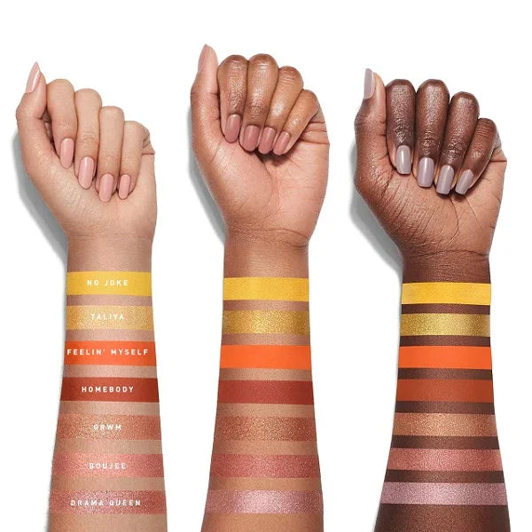 Swatches of colorful eyeshadows on three arms with varying skin tones, showing pigment range.