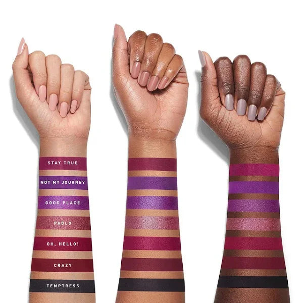 Swatches of colorful eyeshadow shades on three arms with different skin tones.