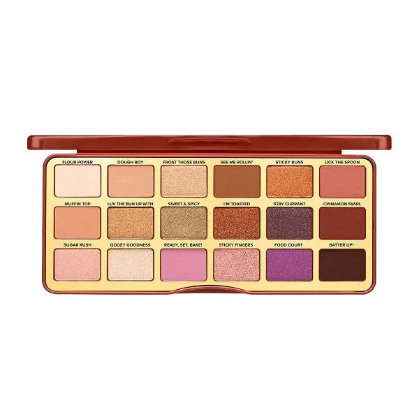 Open eyeshadow palette with 18 warm, neutral, and pink shades in a rectangular case.