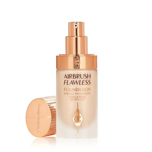 Glass bottle of airbrush flawless foundation with gold pump and cap, makeup product