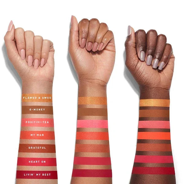 Arm swatches of colorful eyeshadow shades on three different skin tones.